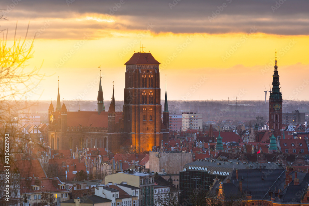 Beautiful cityscape of Gdansk with St. Mary Basilica and City Hall at sunrise, Poland.