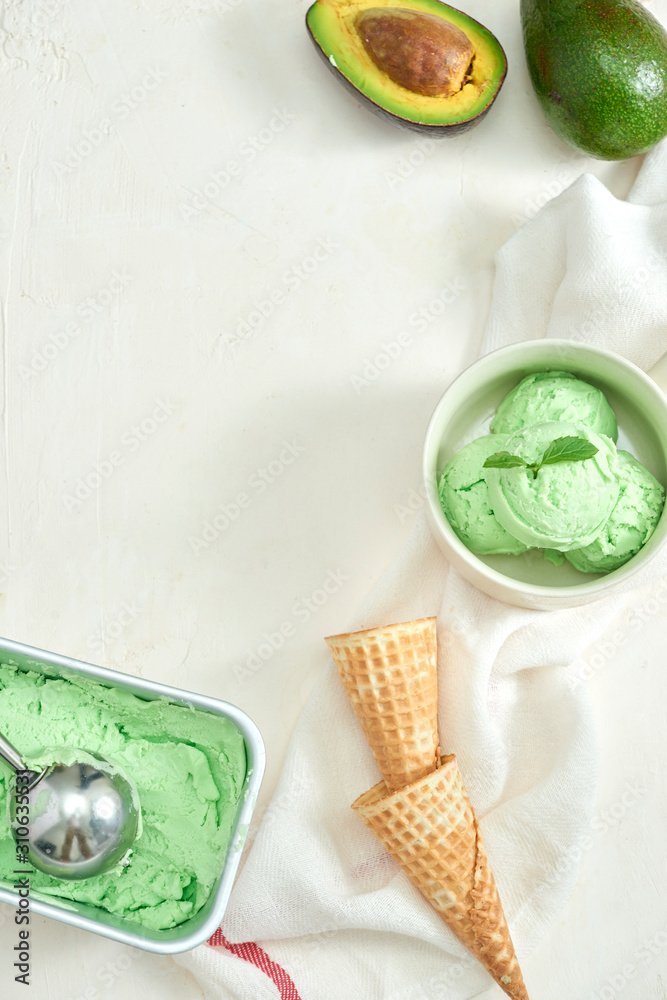 homemade organic avocado ice cream, with ice cream cones. On a grey stone table, copy space