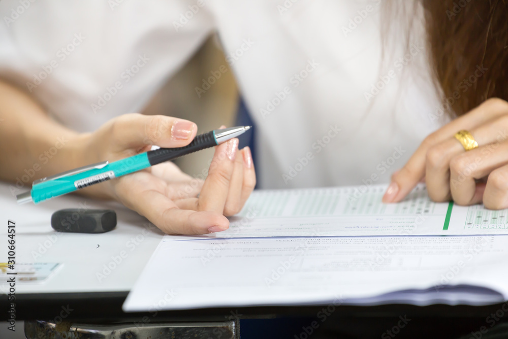 high school,university student study.hands holding pencil writing paper answer sheet.sitting lecture