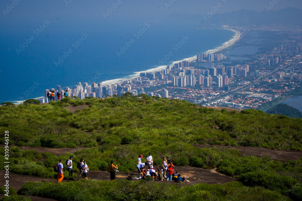 Tourists enjoy the view from the top of Pedra da Gávea, a tourist spot in the city of Rio de Janeiro