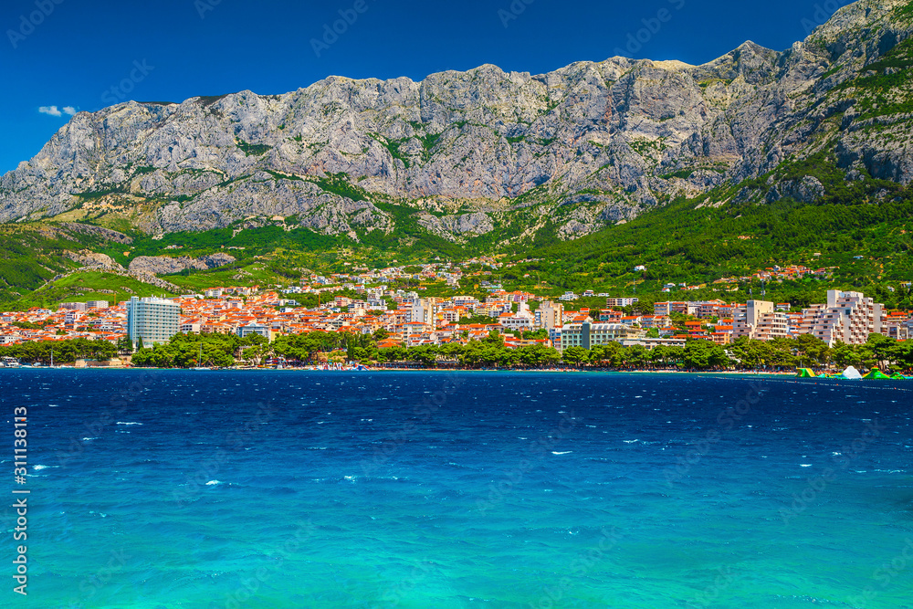 Admirable Makarska cityscape with beach and high mountains, Dalmatia, Croatia