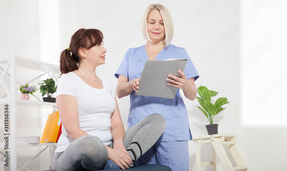 Female patient being reassured by doctor in hospital.