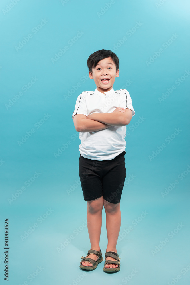 Confident 9 year old boy with arms folded  isolated on a white background