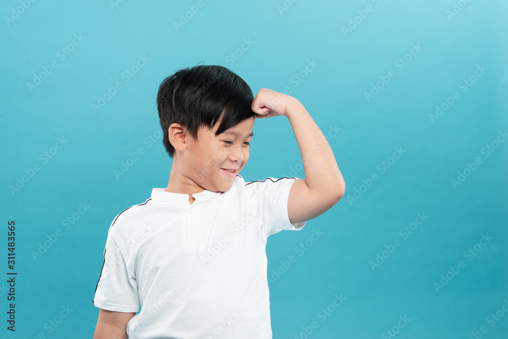 Child. Funny Little Boy.Sport Handsome Boy. Strong. bodybuilder. showing his hand biceps muscles