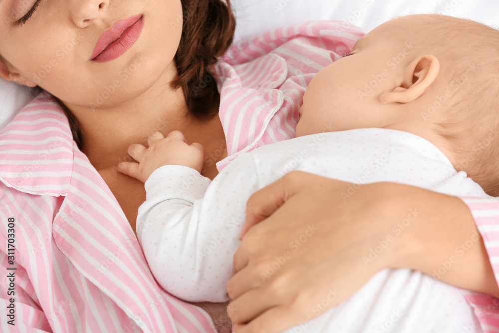 Young woman and her sleeping baby, closeup