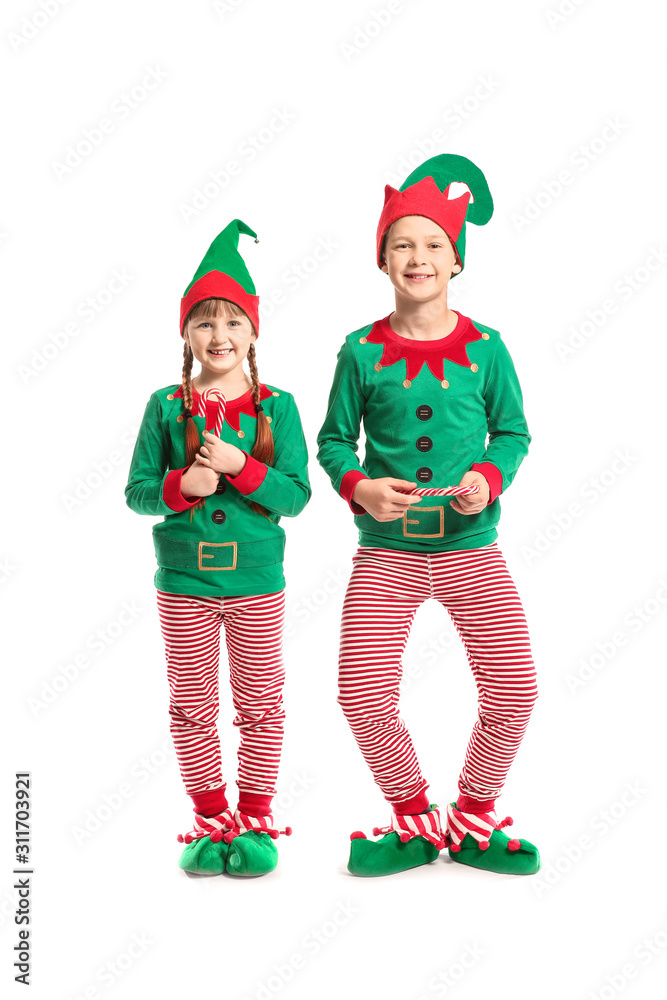 Little children in costume of elf and with candy canes on white background