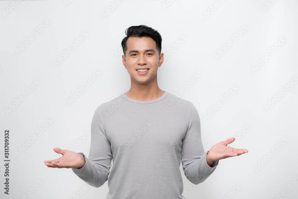 Young Asian man showing welcome sign isolated on white background.