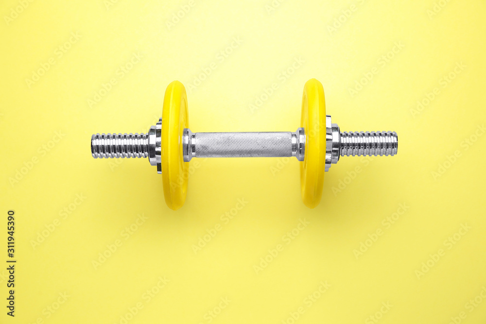 New dumbbell on color background