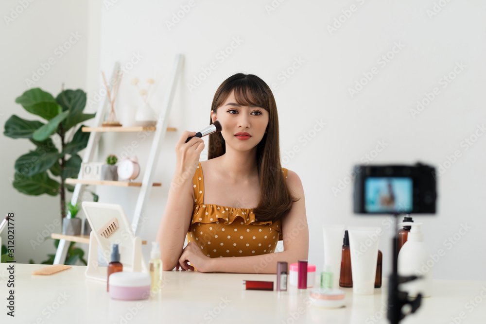 woman show makeup brush in live at home