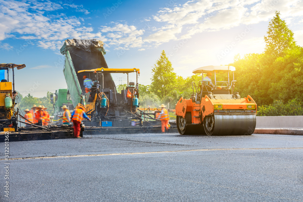 Construction site is laying new asphalt road pavement,road construction workers and road constructio