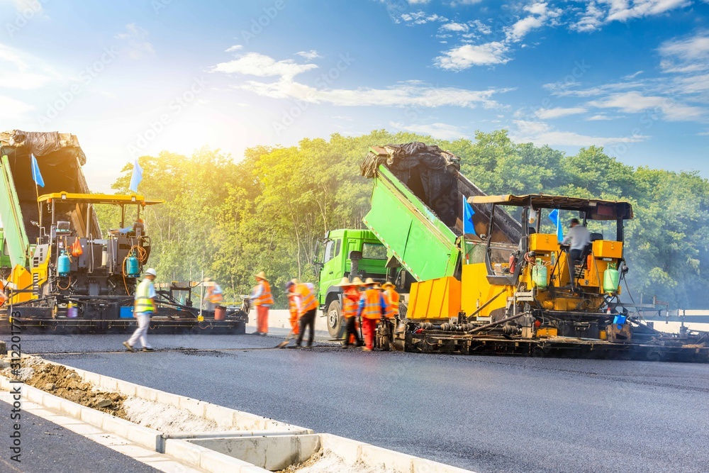 Construction site is laying new asphalt road pavement,road construction workers and road constructio