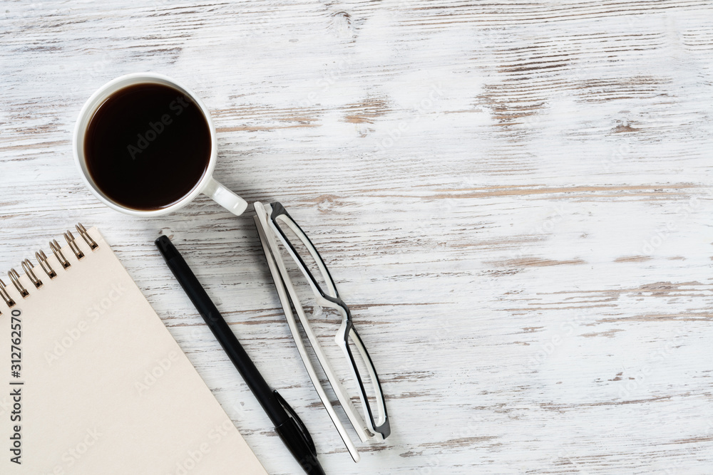 Top view office desk with white cup of coffee