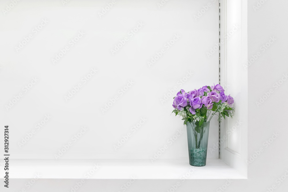 White shelf against white wall with a pot.