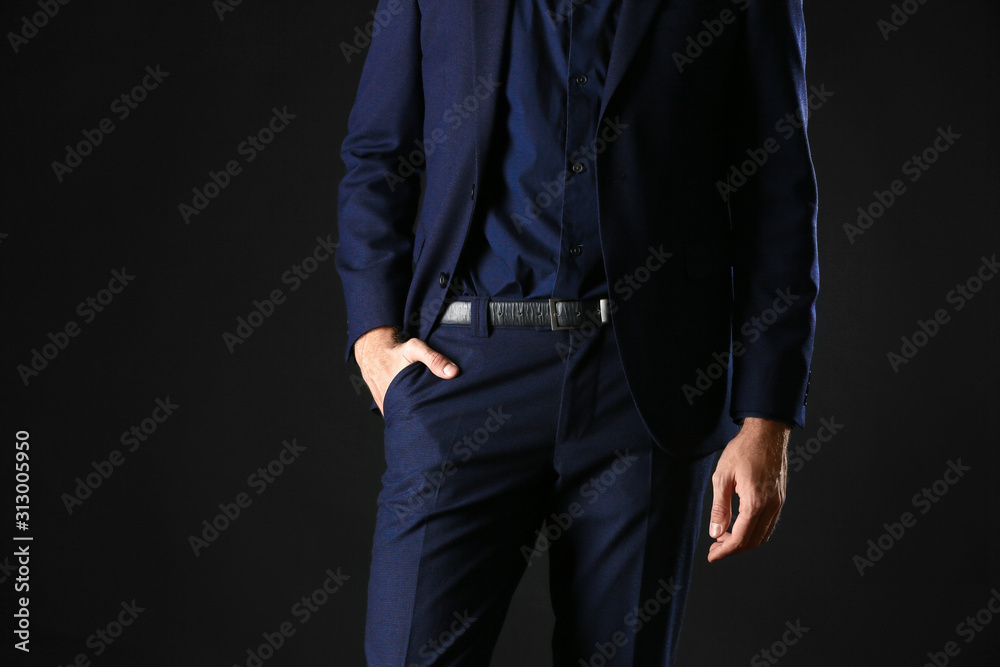 Man in stylish blue clothes on dark background