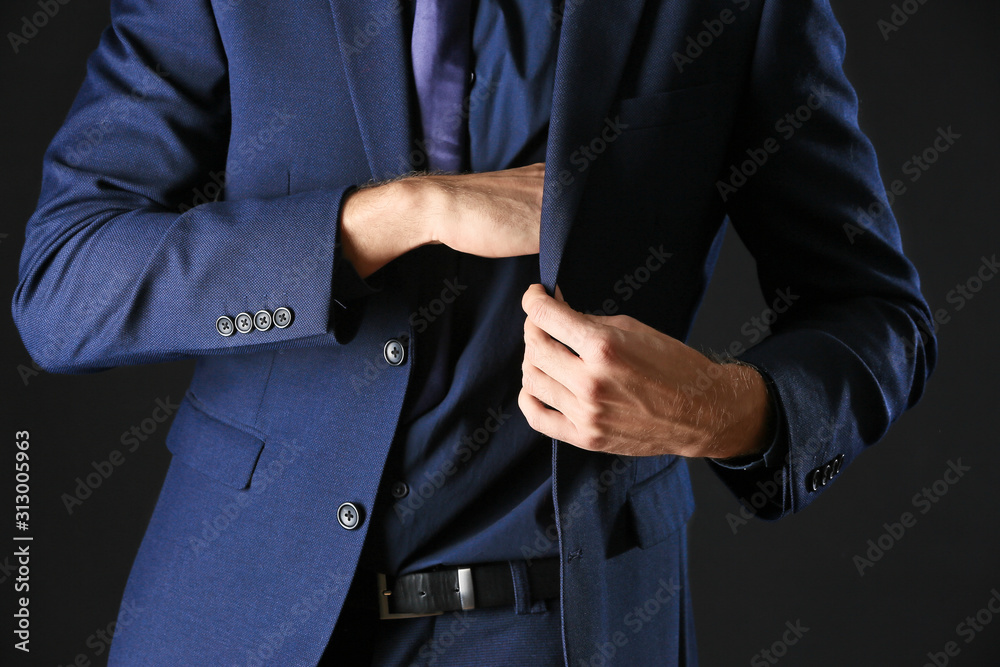 Man in stylish blue clothes on dark background