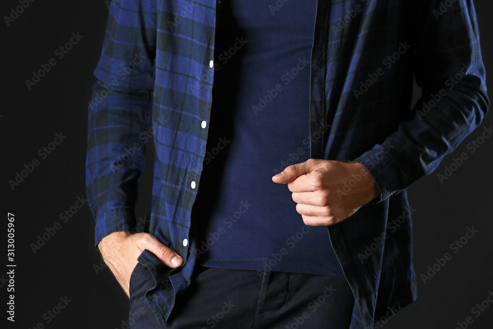 Man in stylish blue clothes on dark background