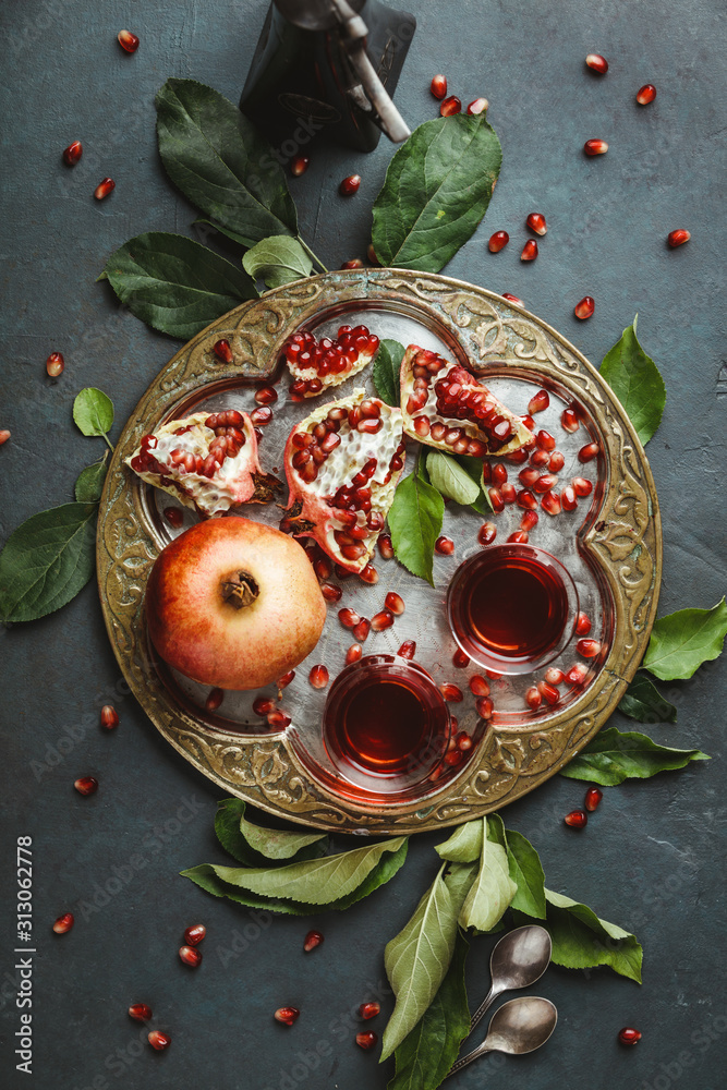 Pomegranate tea on dark background, flat lay