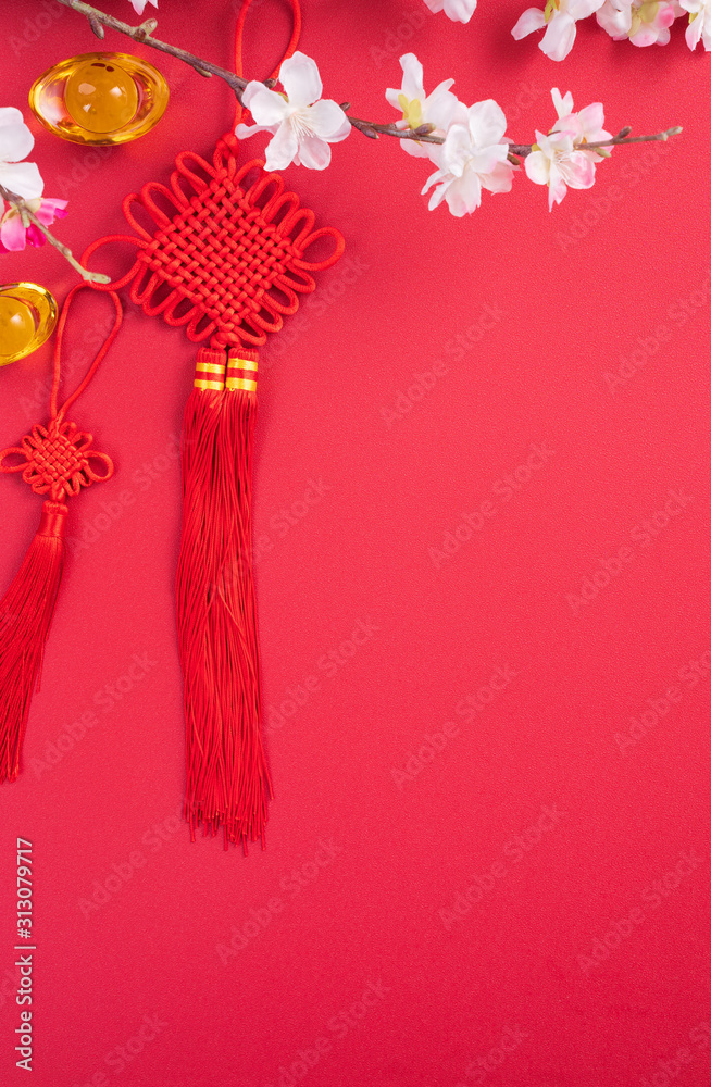 Design concept of Chinese lunar new year - Beautiful Chinese knot with plum blossom isolated on red 