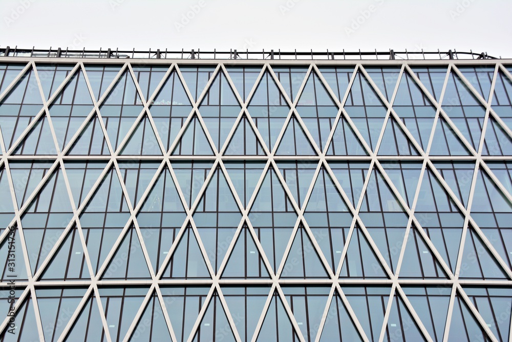 Abstract image of looking up at modern glass and concrete building. Architectural exterior detail of