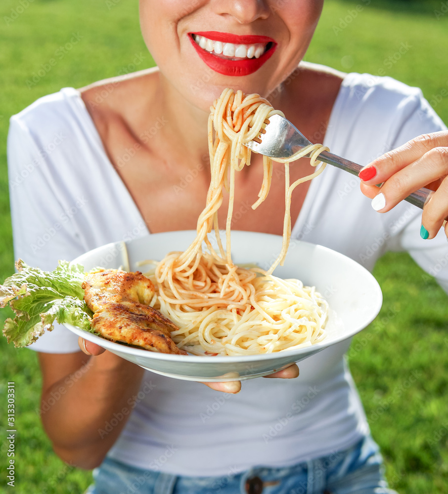 Young brunette woman eating spaghetti