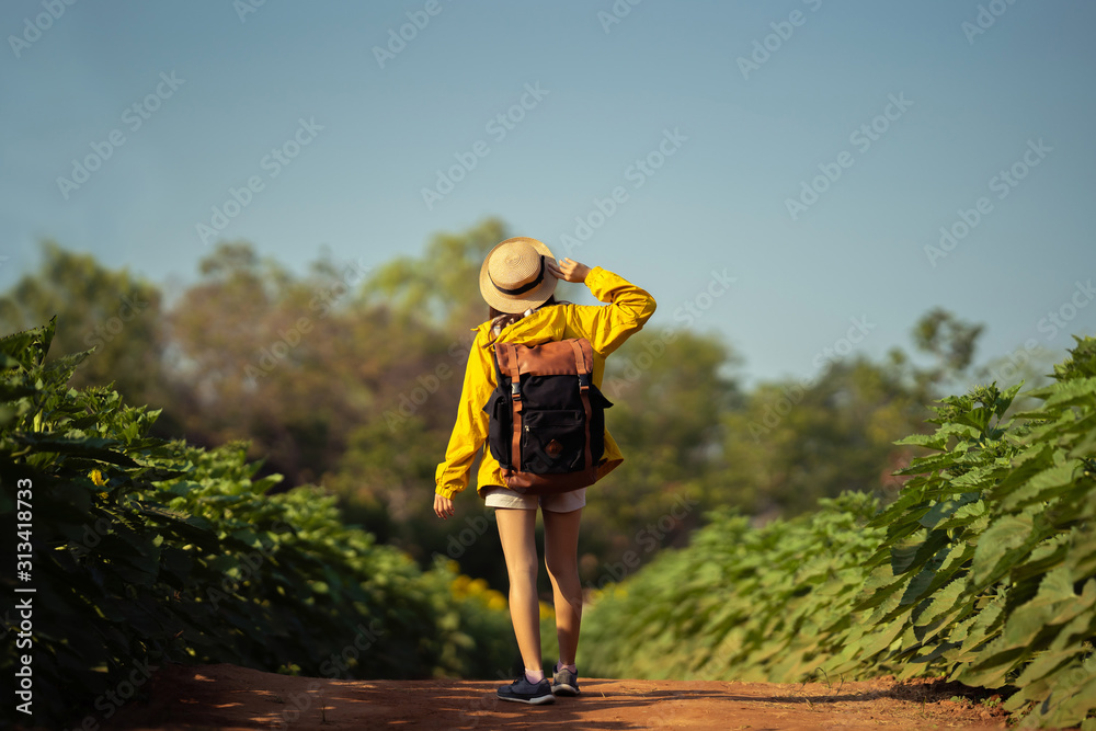 Asian women tourists she is traveling alone in the flower field