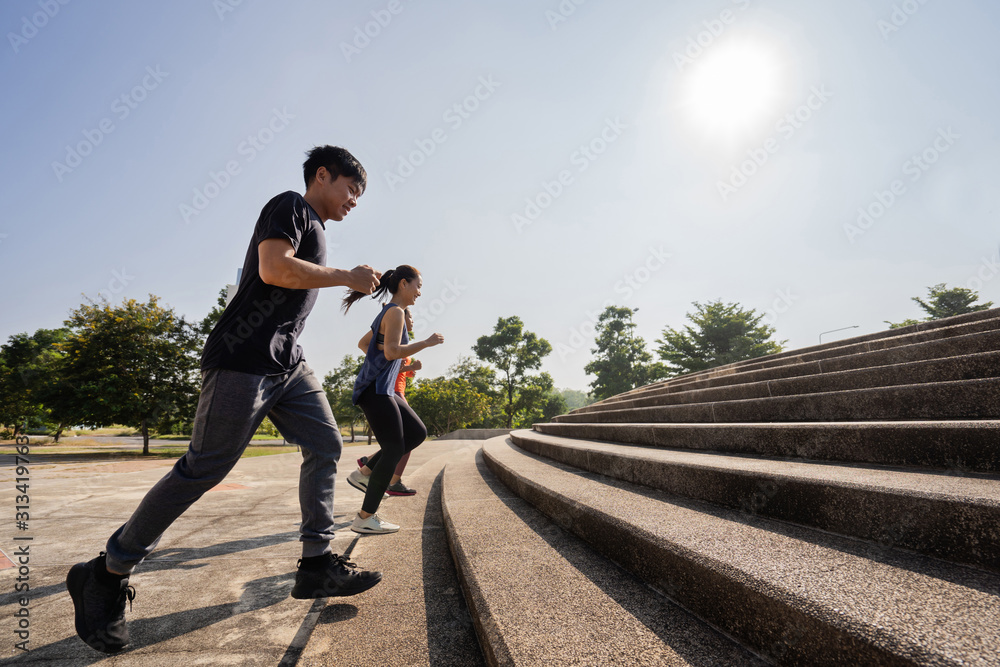 Asian friends group jogging up the stairs