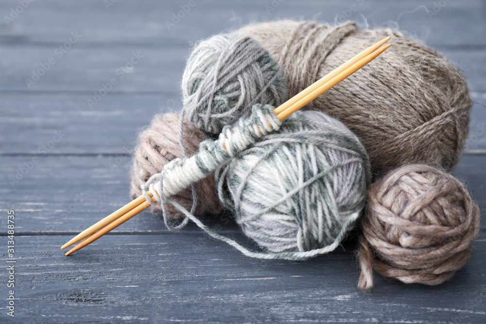 Knitting yarn and needles on wooden table