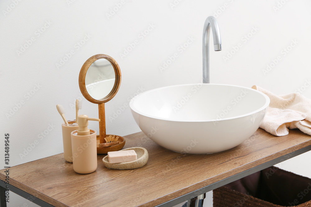 Body care cosmetics with accessories near sink in bathroom