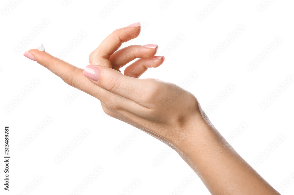 Hand of young woman with cosmetic cream on white background