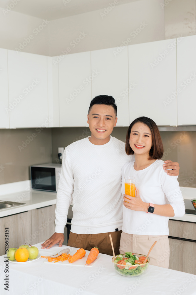 Loving couple cooking together in the kitchen at home