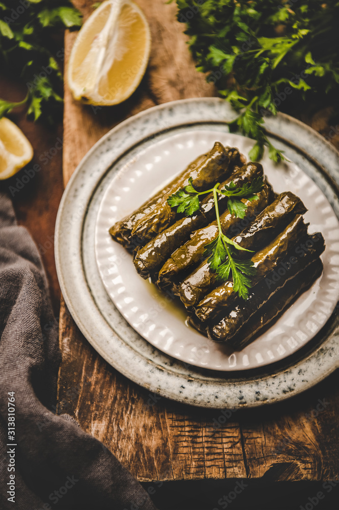 Turkish traditional wine leaves Sarma or Dolma filled with rice and spices garnished with olive oil,