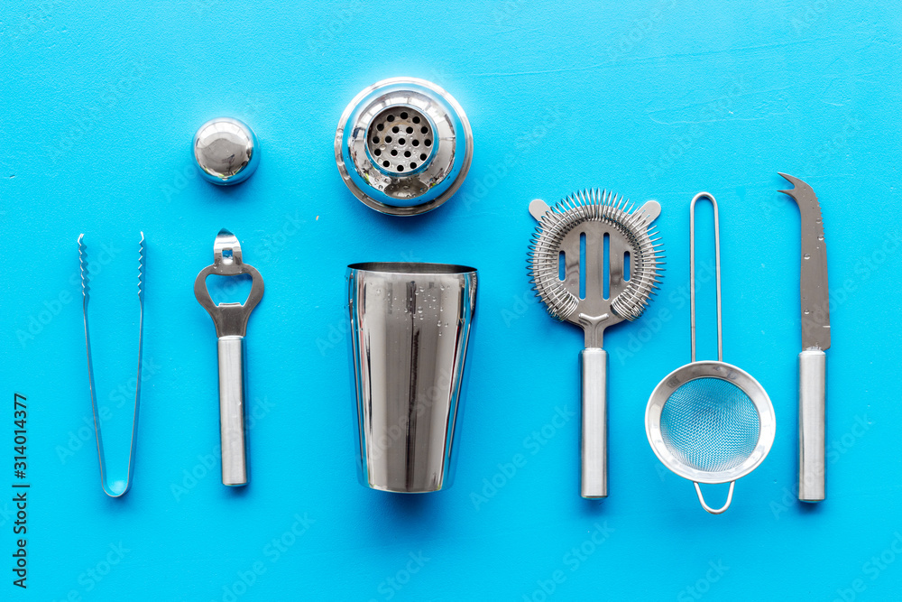 Bartender equipment set with shaker and stainer on blue background top-down pattern