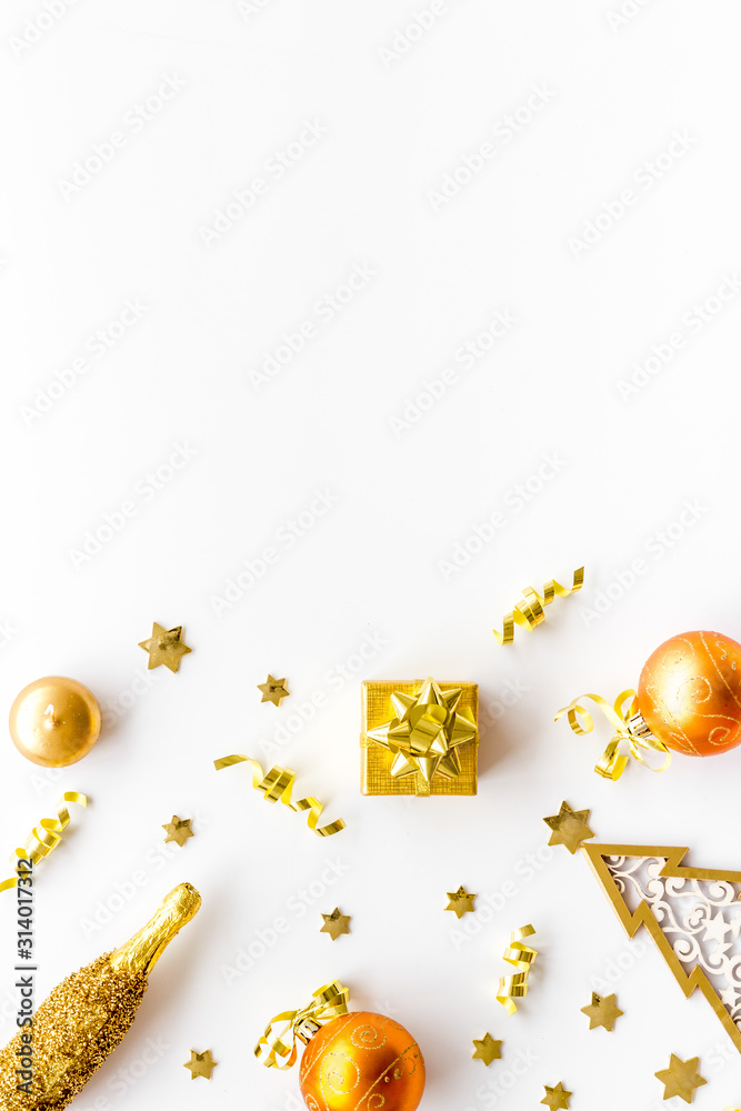 New Year symbols - tree, champagne, decorations - on white background top-down frame copy space