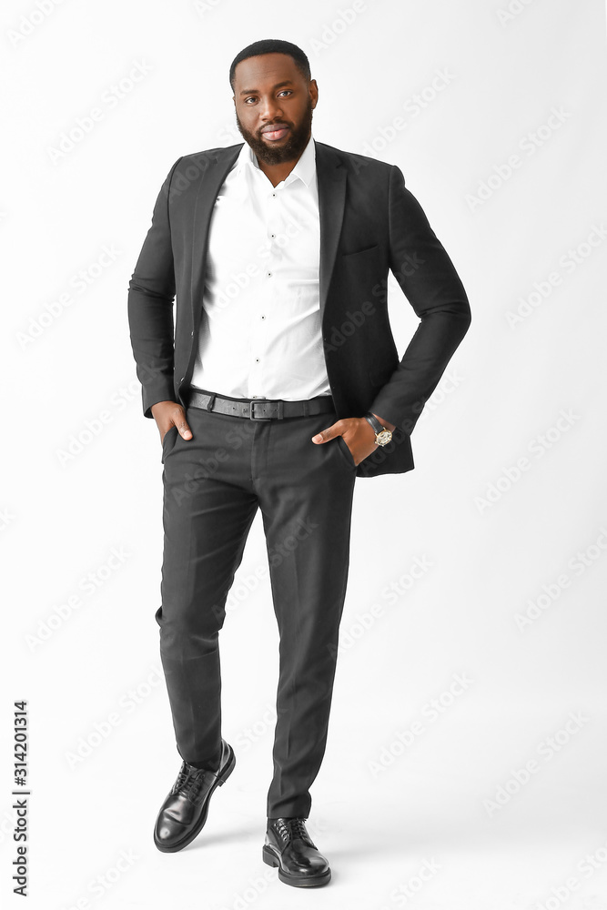 Stylish African-American man on white background