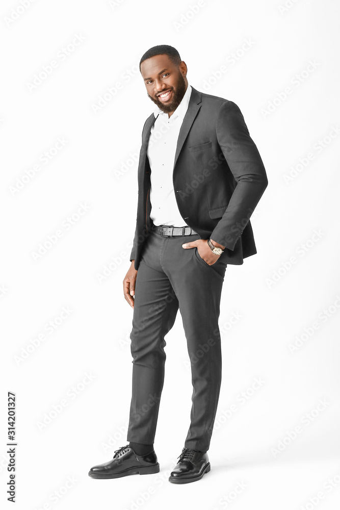 Stylish African-American man on white background