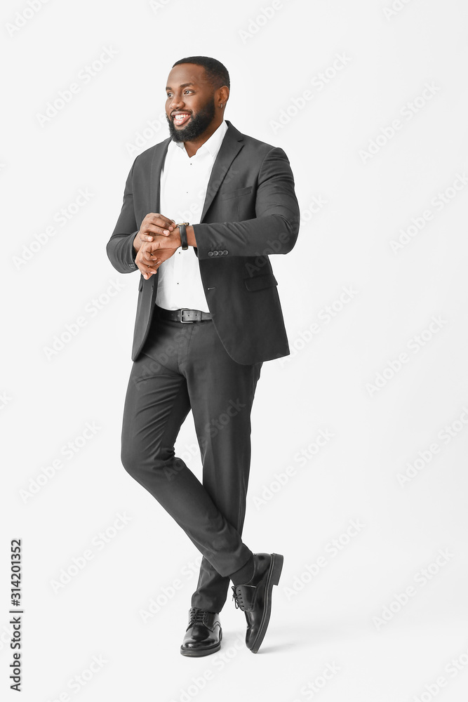 Stylish African-American man on white background