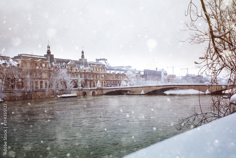 Flooded Seine river in Paris downtown under snow