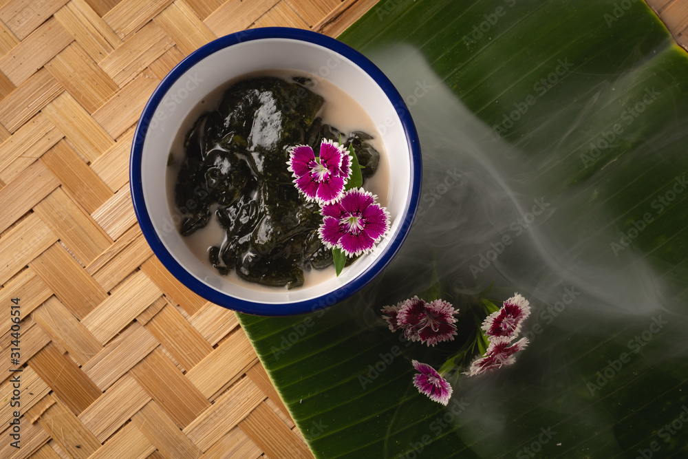 Thai dessert, Icevine, Pareira barva with coconut milk on wooden table, Top view