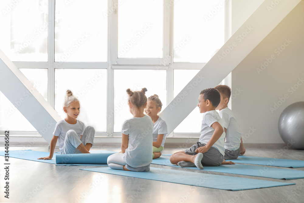 Little children practicing yoga in gym