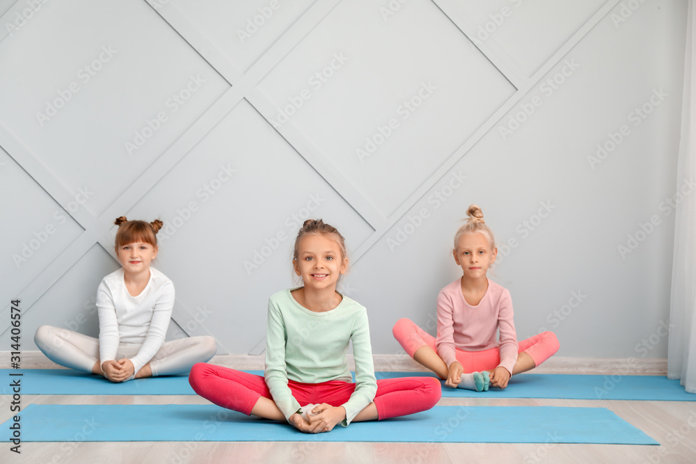 Little children practicing yoga in gym