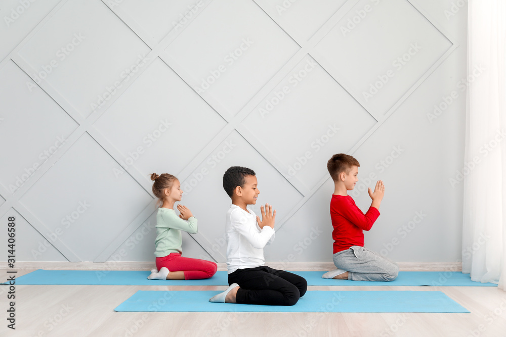 Little children practicing yoga in gym