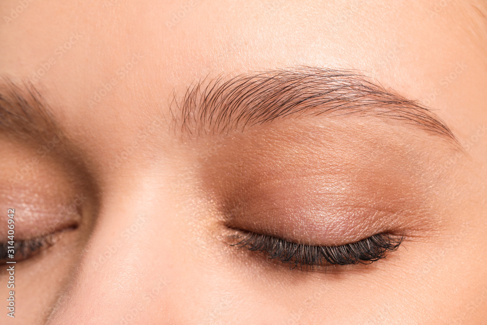 Young woman with beautiful eyebrows, closeup