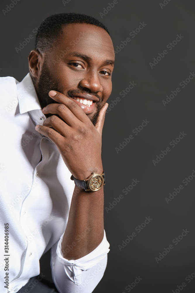 Stylish African-American man on dark background