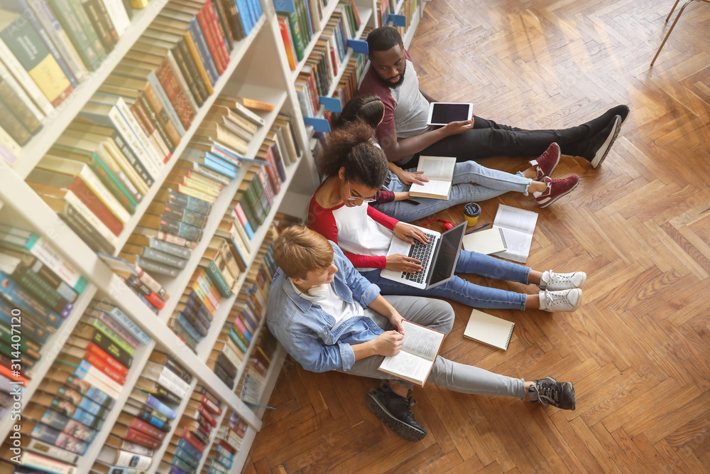 Young students preparing for exam in library