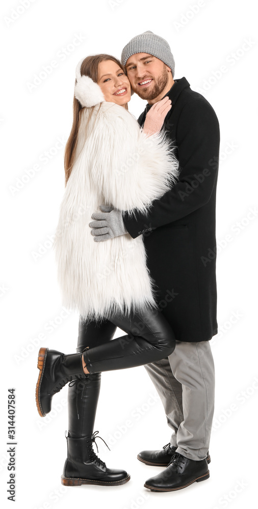 Portrait of happy couple in winter clothes on white background