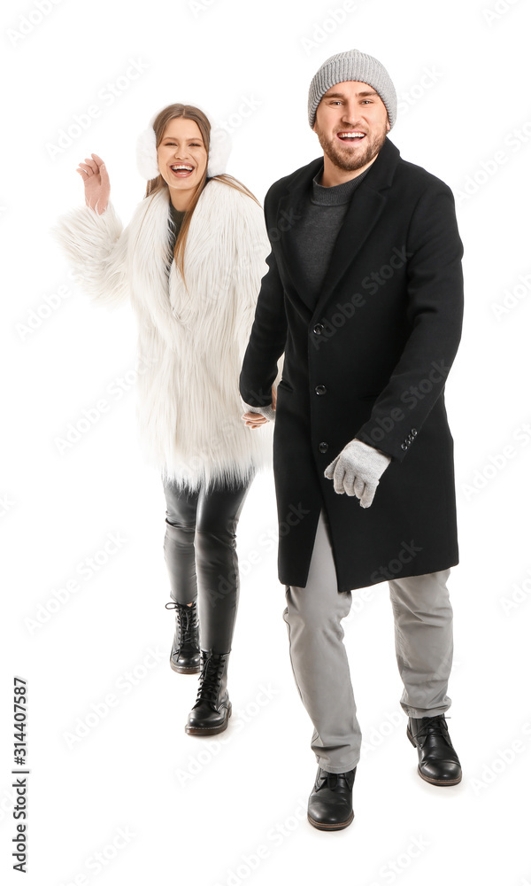 Portrait of happy couple in winter clothes on white background