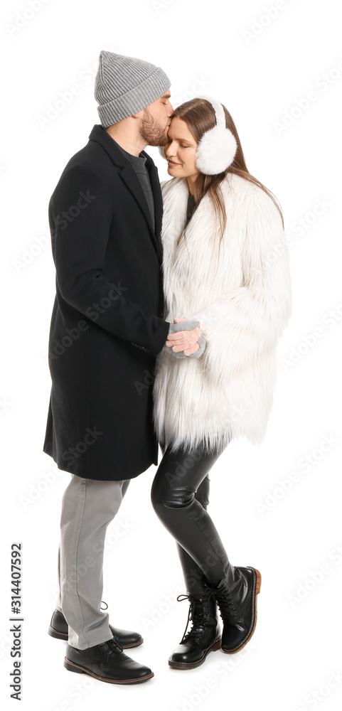 Portrait of happy couple in winter clothes on white background