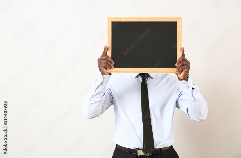 African-American teacher with chalkboard on white background