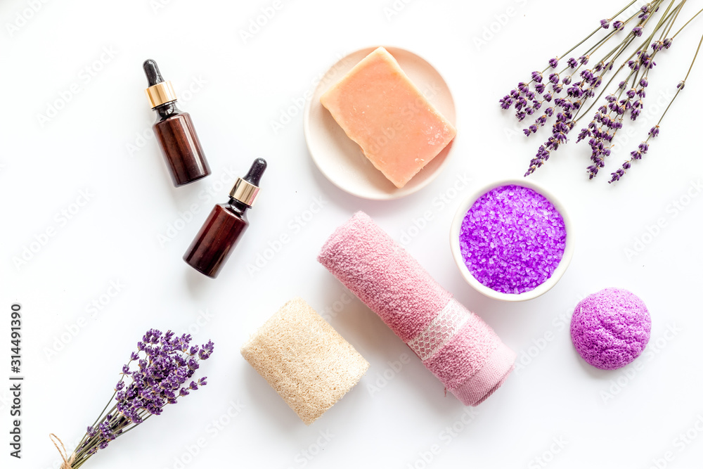 Lavender spa set. Violet bath salt, soap, essence oil on white background top-down