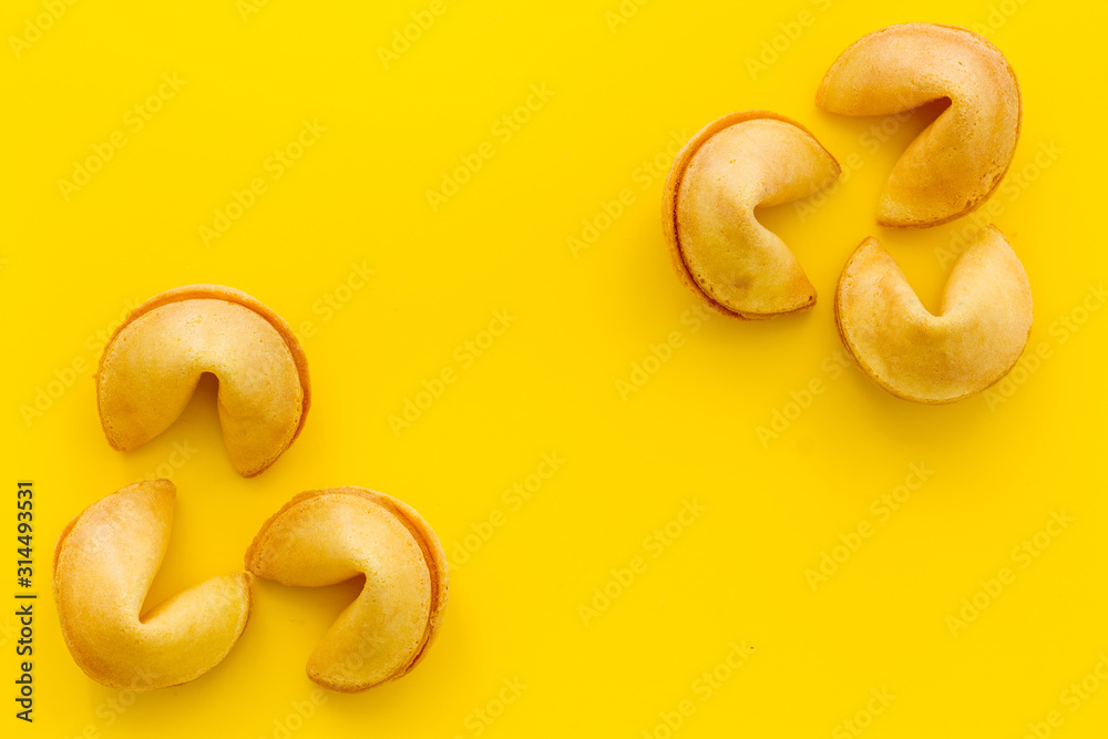 Fortune cookie frame on yellow background top-down copy space